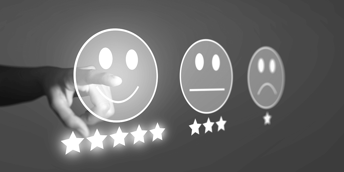 Finger pointing to a smiley with five stars beneath.