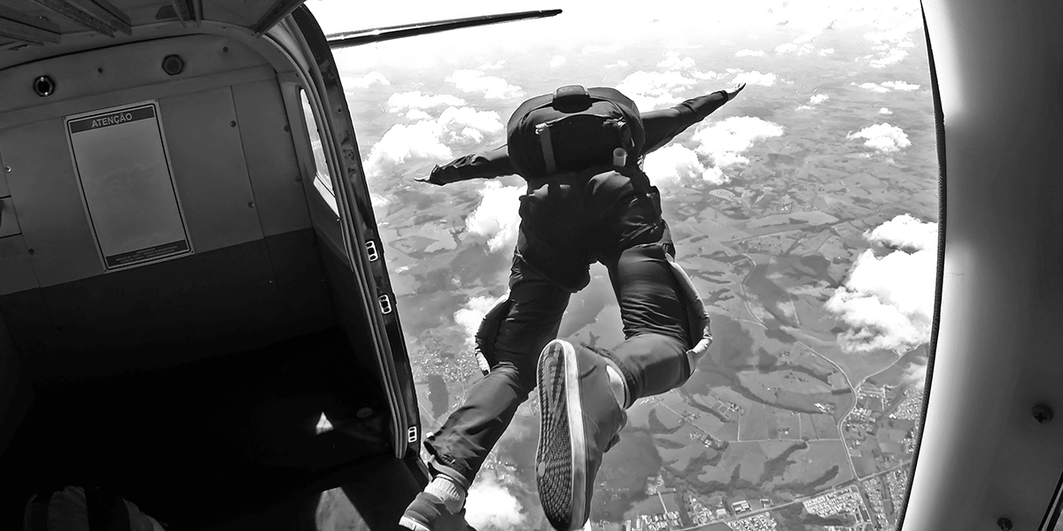 Skydiver leaping out of an airplane.
