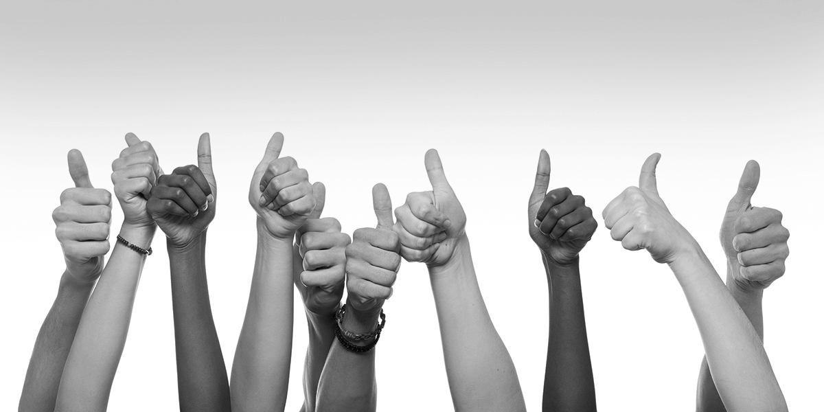 A group of thumbs in the air to show agreement on a CRM for business development.